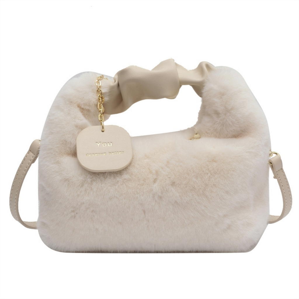 Beige fur handbag with a gold chain and tag on a white background