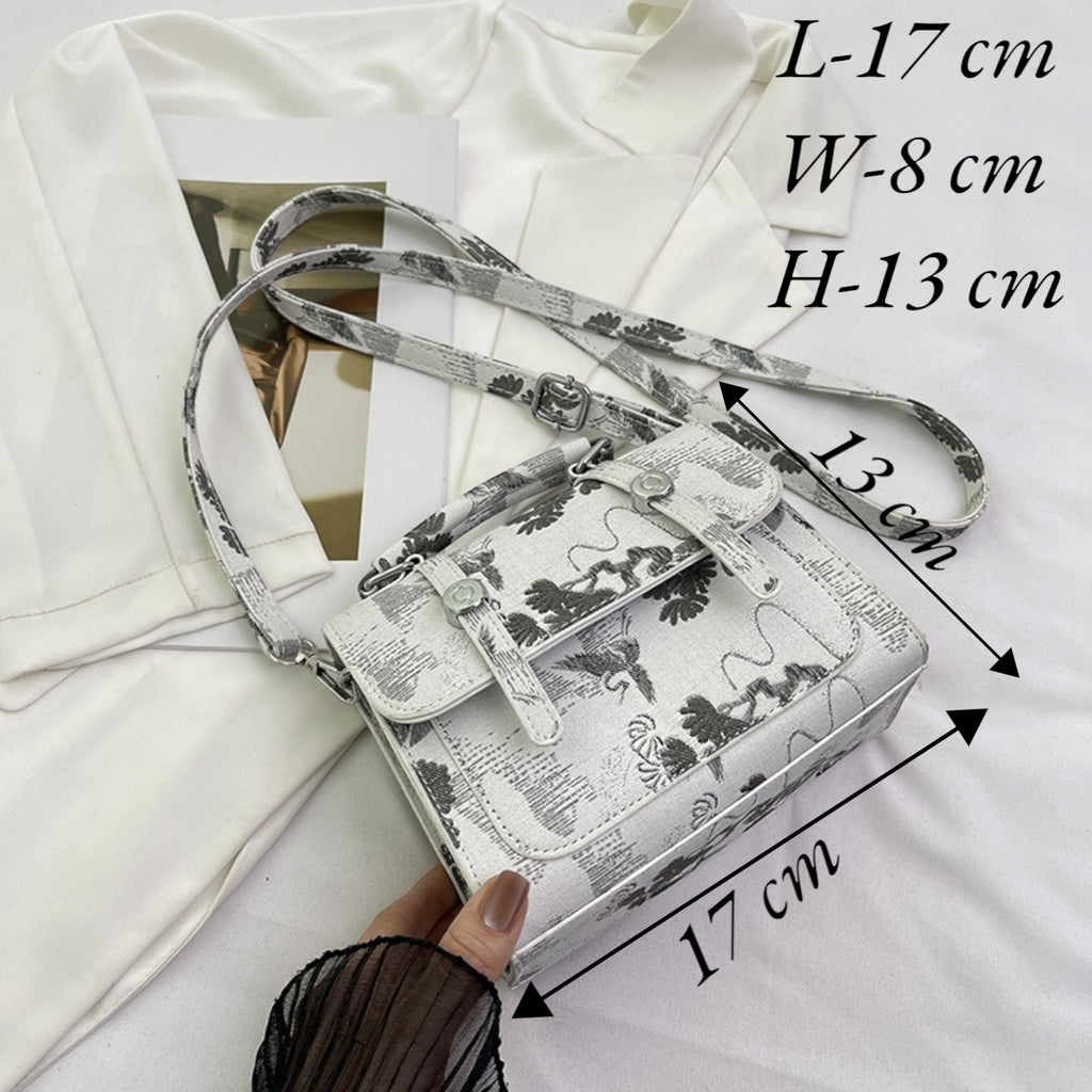 A small shoulder bag with a white and gray animal print pattern, shown with dimension annotations indicating measurements of 17 cm length, 8 cm width, and 13 cm height. A hand is holding the bag, and it is styled on a white fabric background.